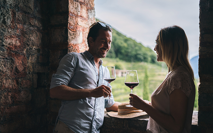 a man and woman holding wine glasses