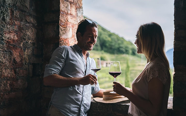 a man and woman holding wine glasses