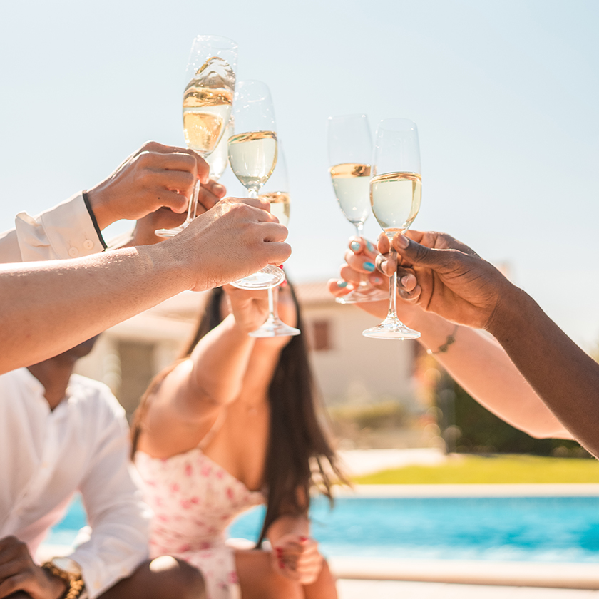 a group of people holding wine glasses