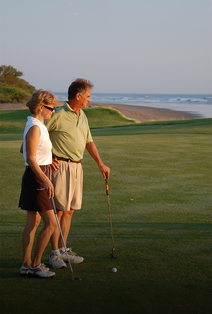 a man and woman holding golf clubs