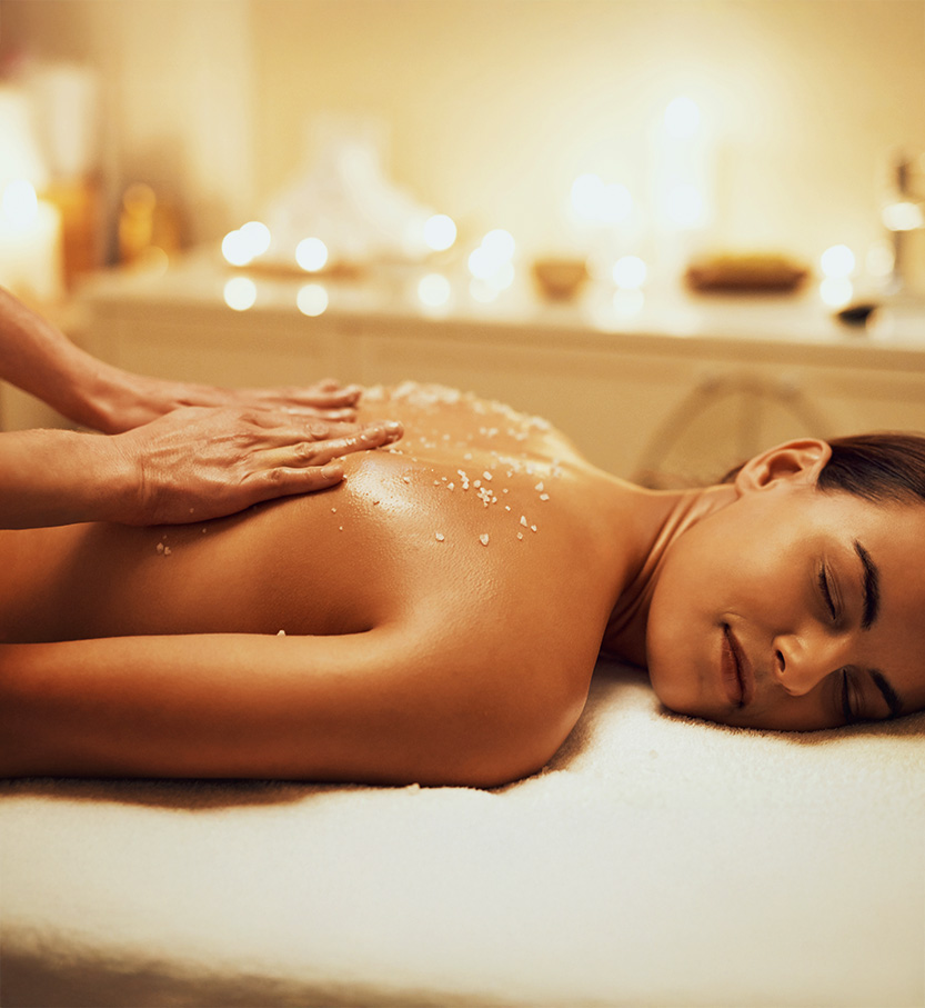 a woman lying down with salt on her back