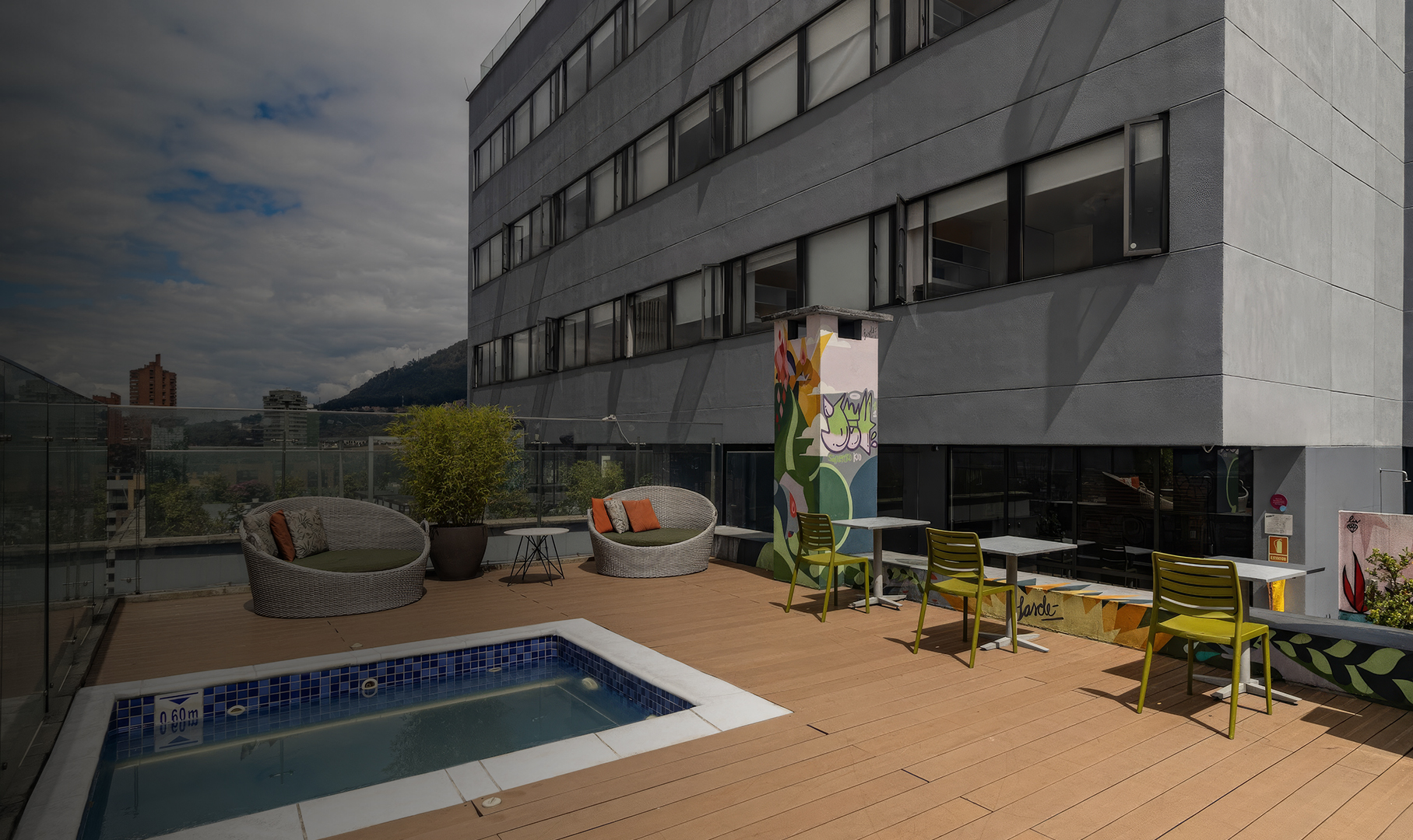 a building with a pool and chairs