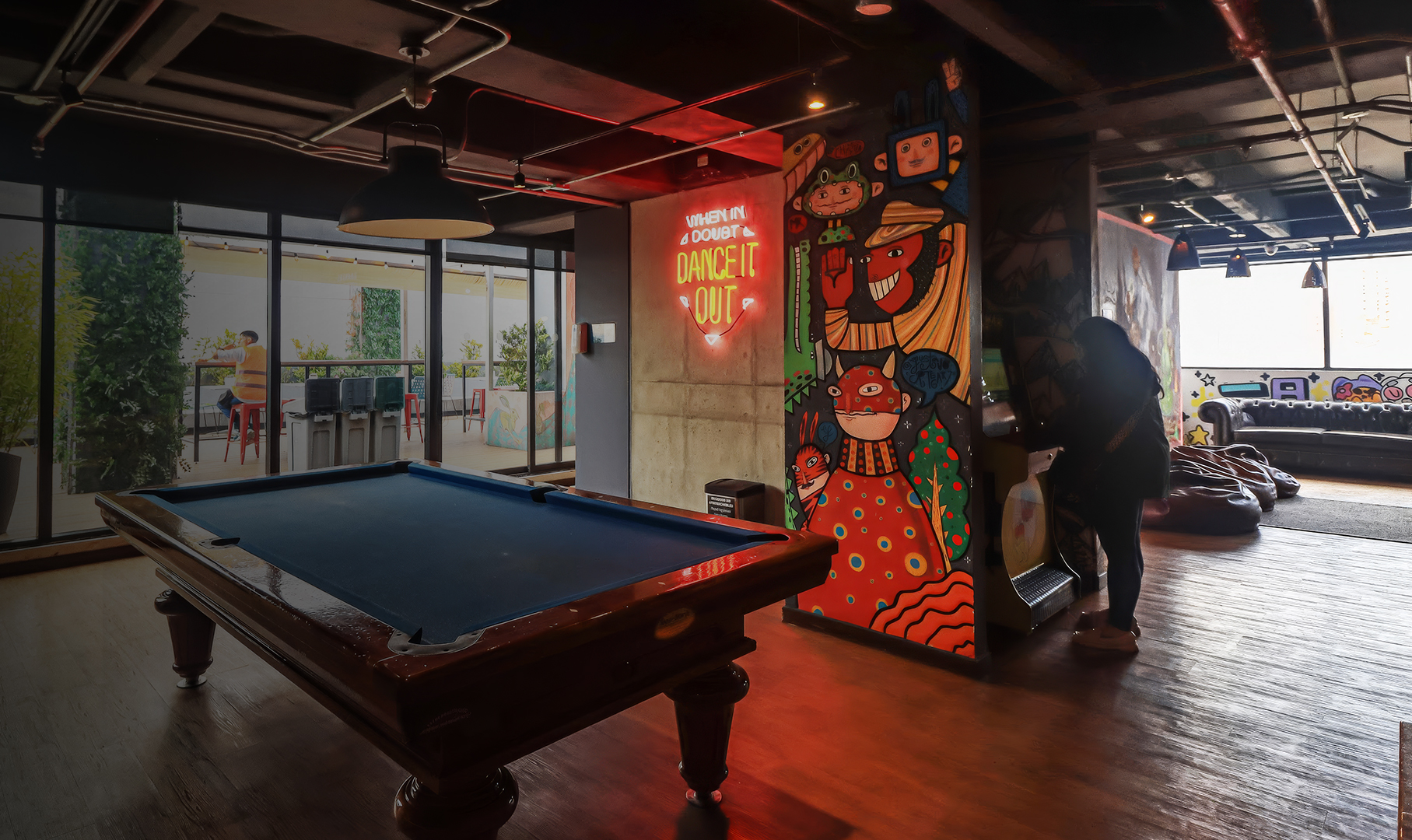 a pool table in a room with a red sign