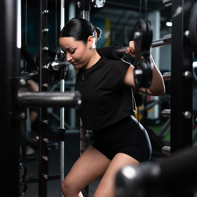 a woman lifting weights in a gym