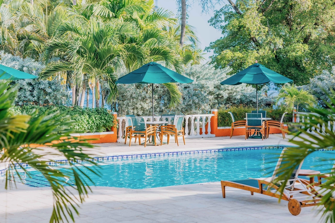 a pool with chairs and umbrellas