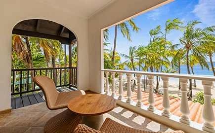 a balcony with chairs and a table