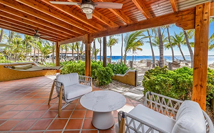 a patio with chairs and a table