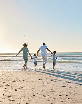 a family running on a beach