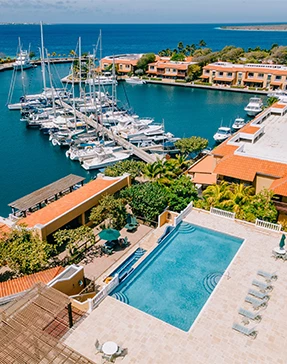 a swimming pool and boats in a harbor