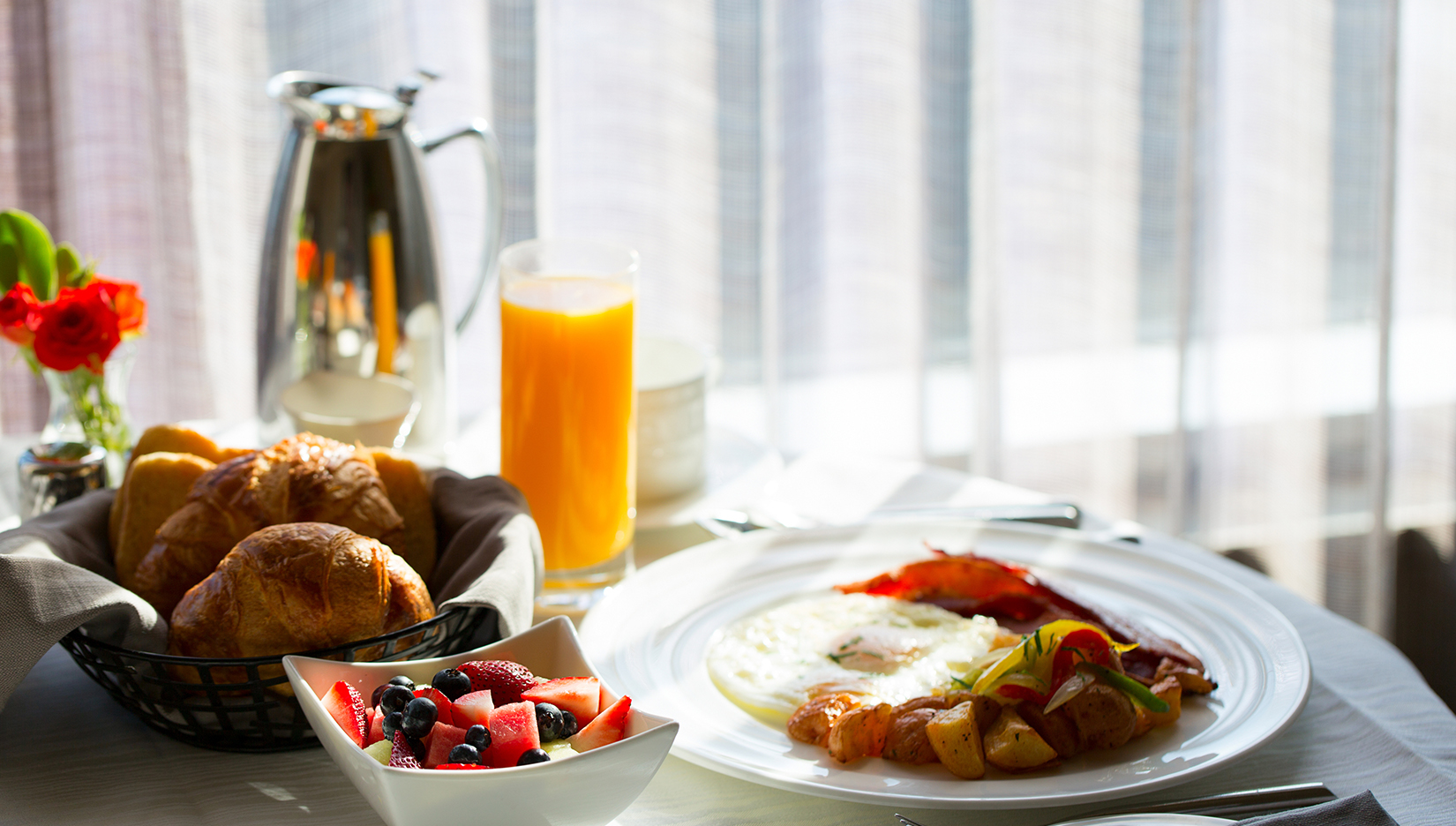 a plate of food and a glass of juice