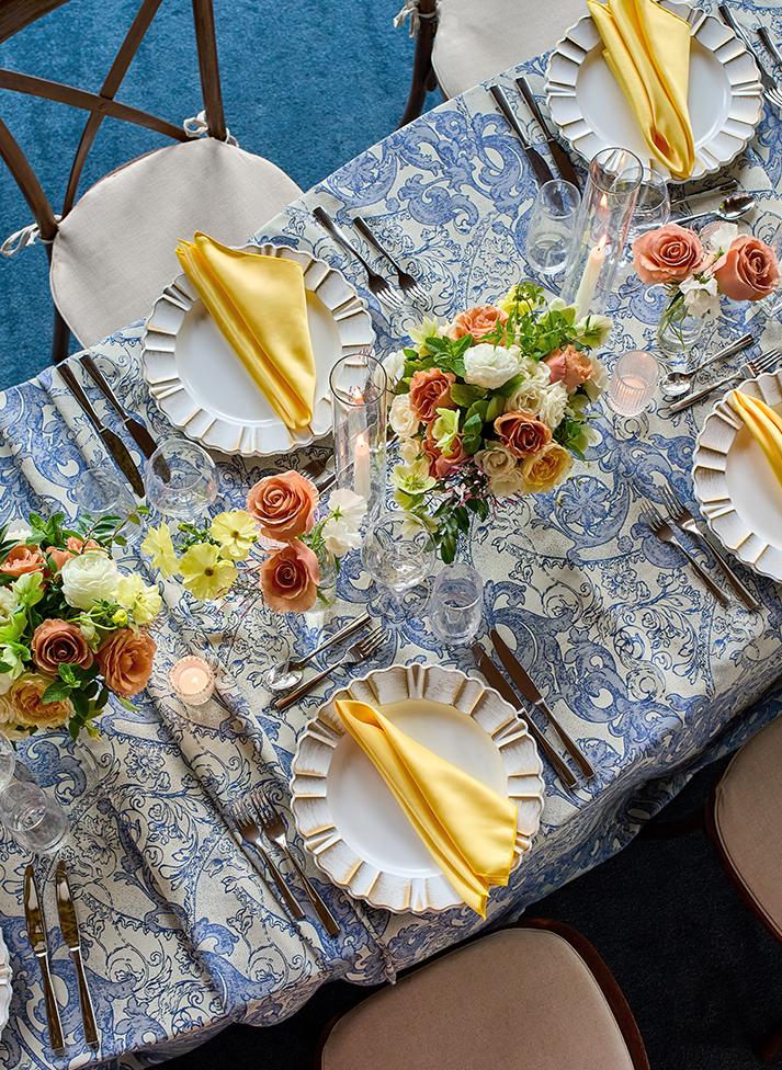 a table set with plates and flowers