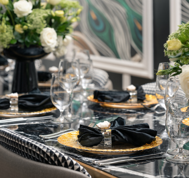 a table with plates and glasses and flowers
