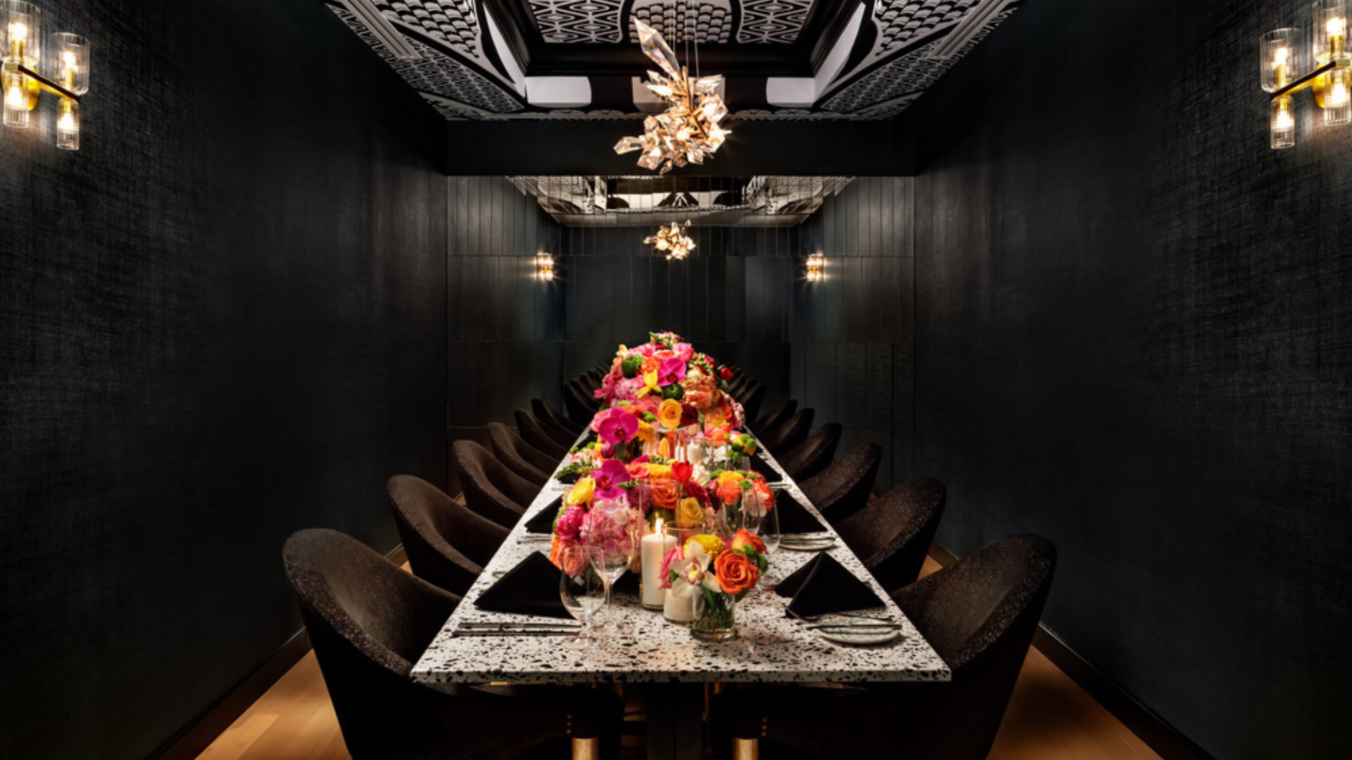 a long table with flowers and wine glasses