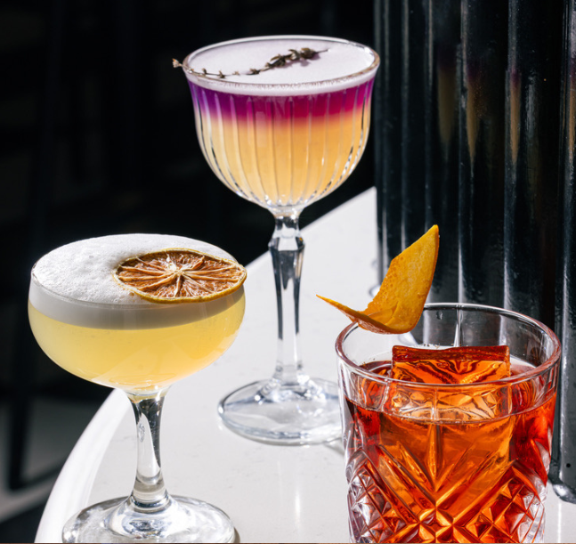 a group of different colored drinks