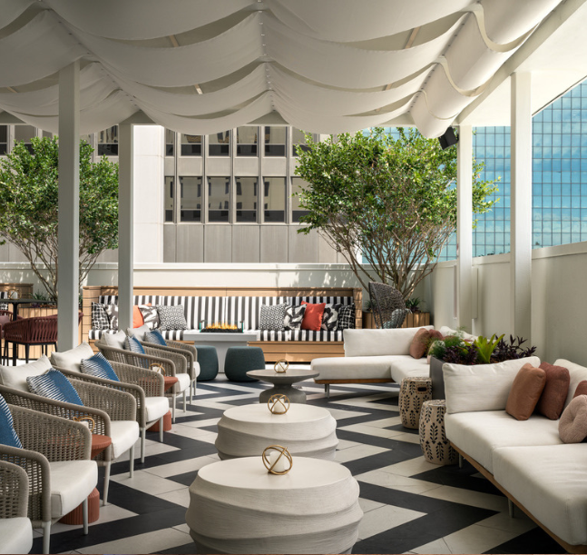 a patio with white couches and tables