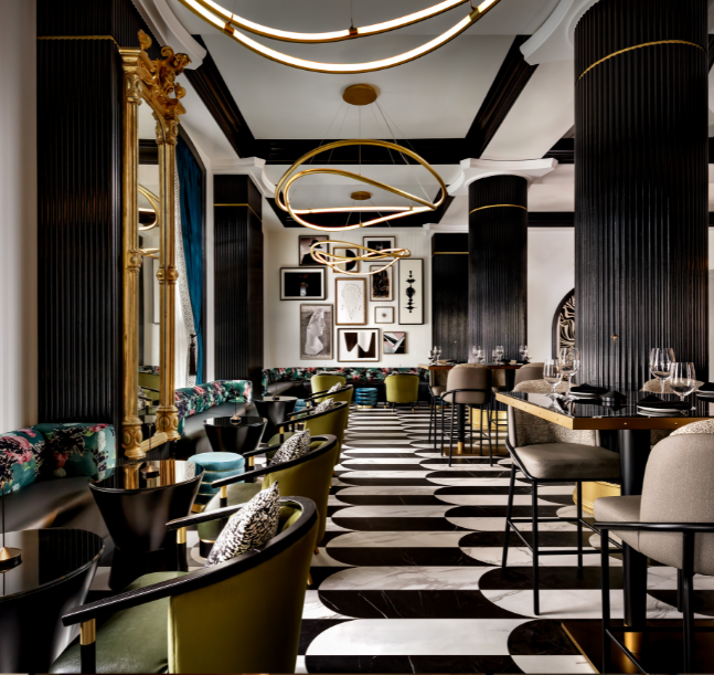 a room with black and white checkered flooring and tables and chairs