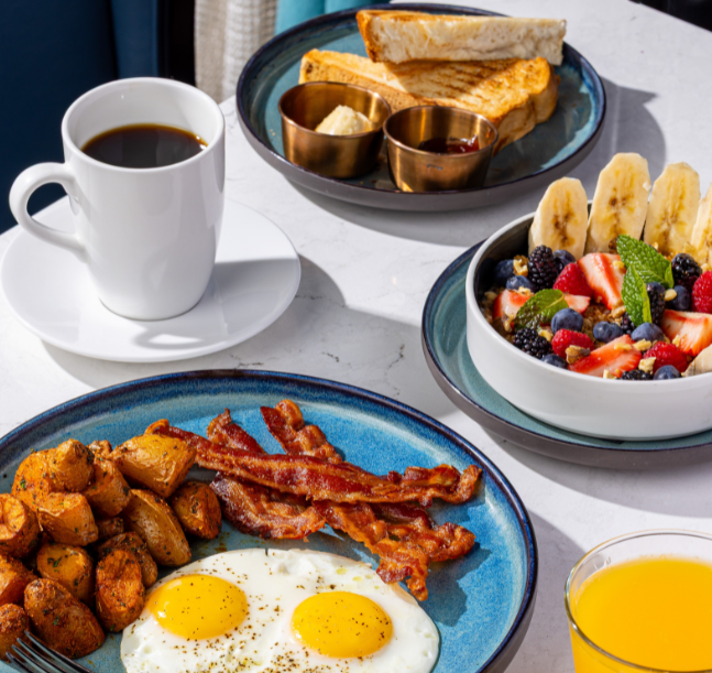 a plate of food and a cup of coffee