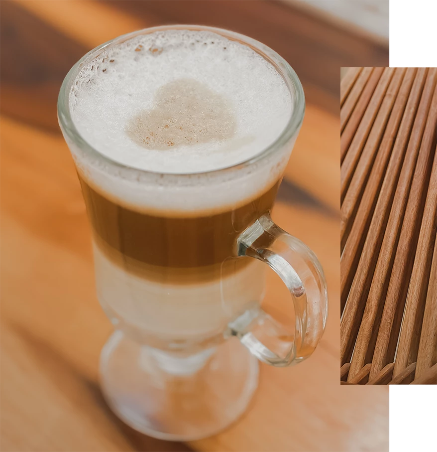 a glass of coffee with a heart in the foam