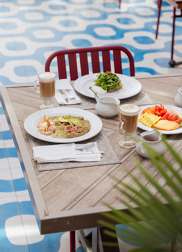 a table with plates of food and drinks