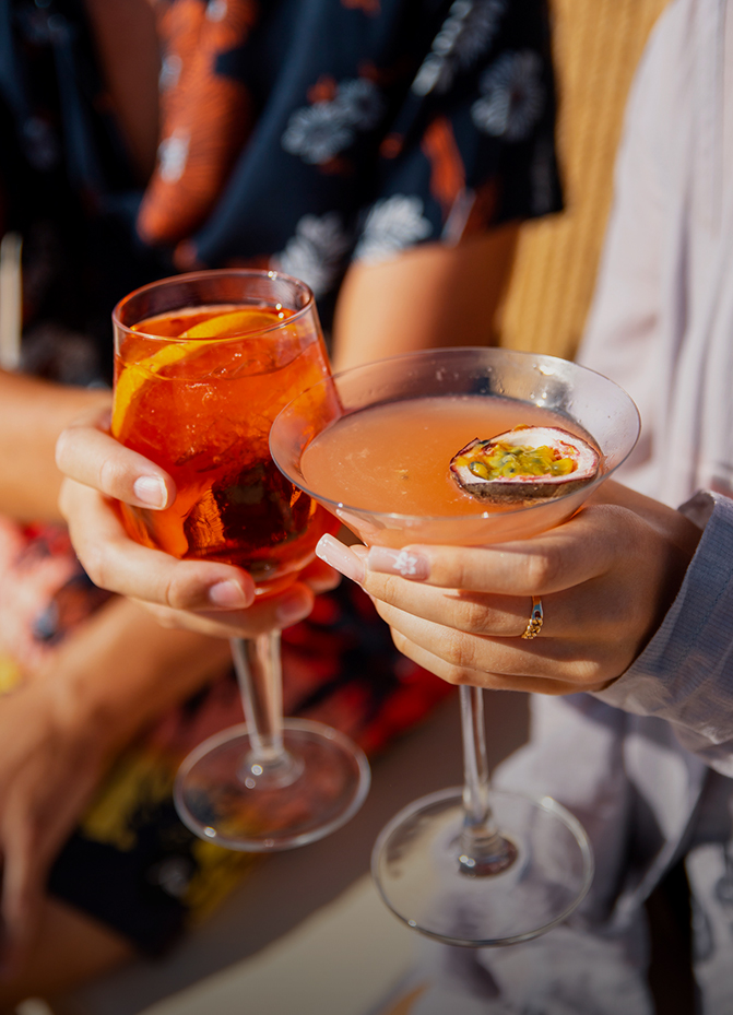 a pair of hands holding drinks