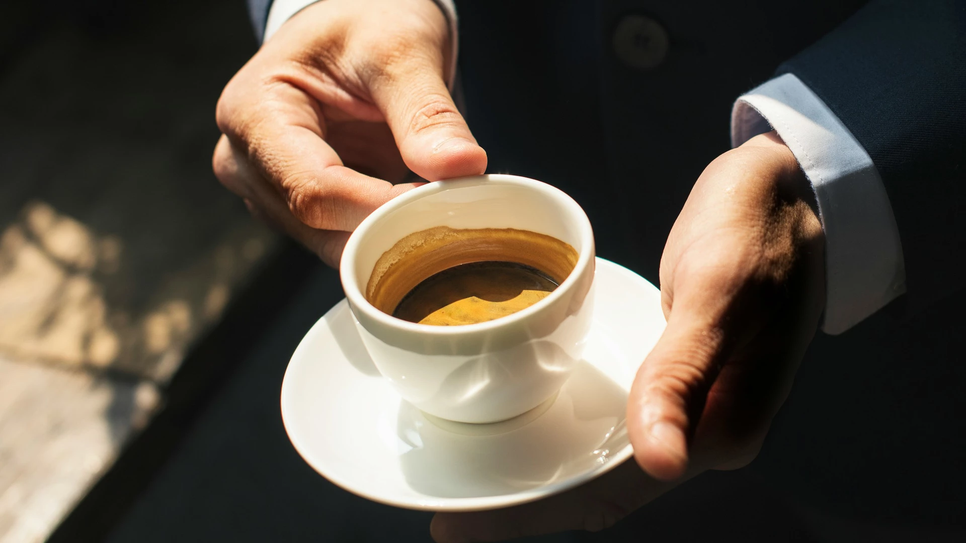 a person holding a cup of coffee