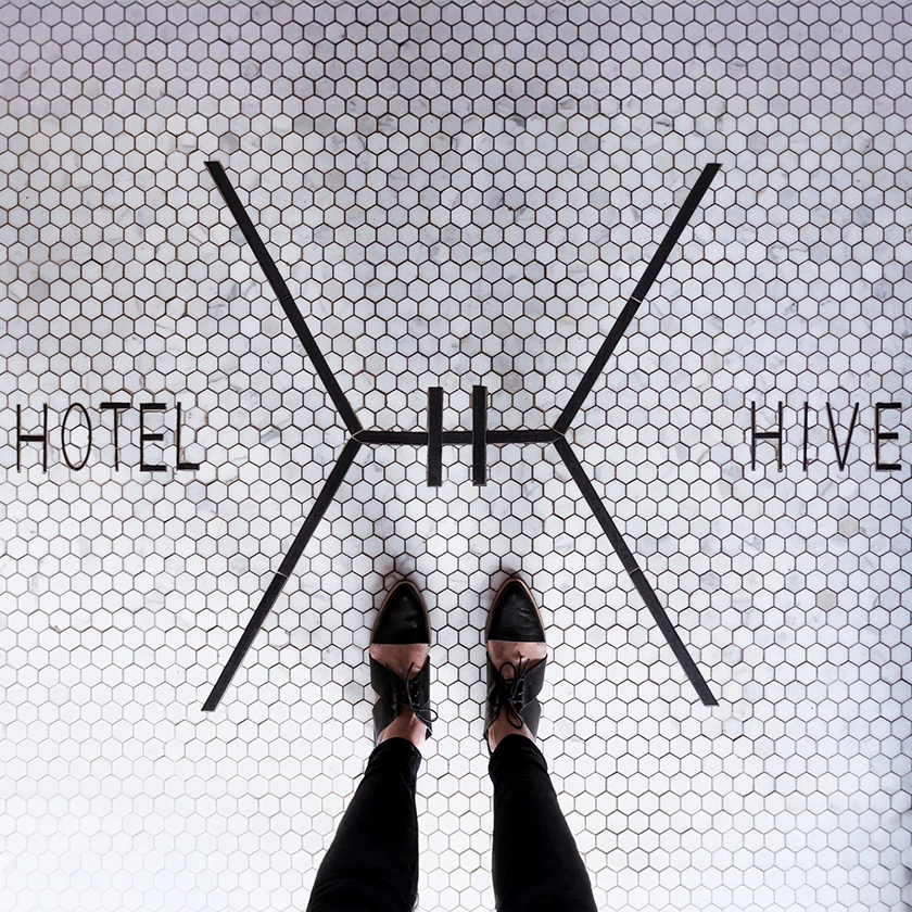a person standing on a tile floor