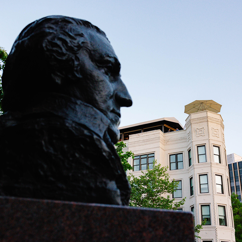 a statue of a man in front of a building