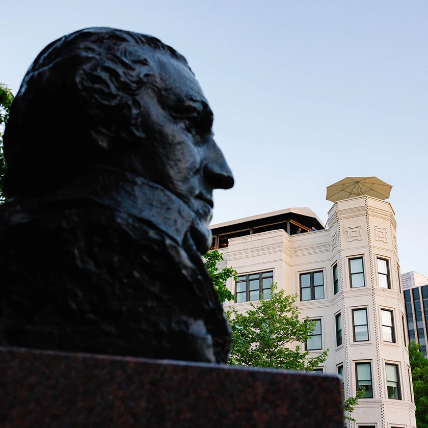 a statue of a man in front of a building