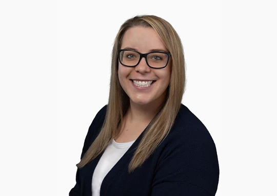 a woman wearing glasses smiling