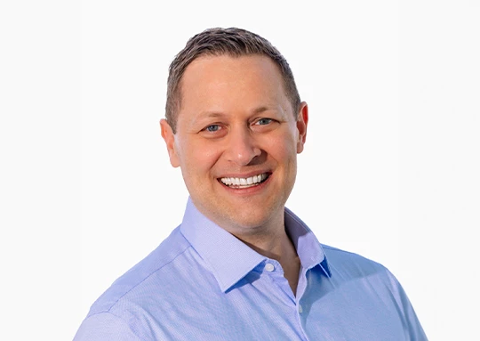 a man smiling at the camera