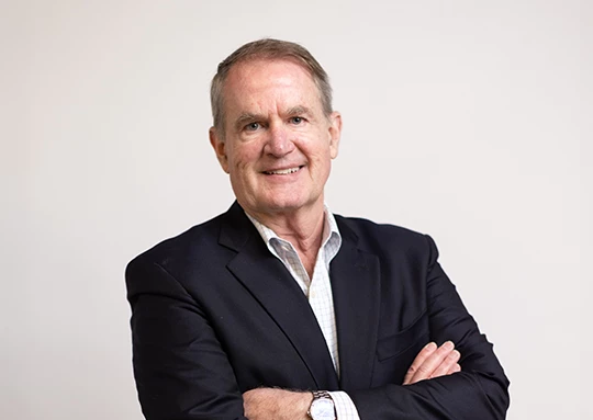 a man in a suit with his arms crossed