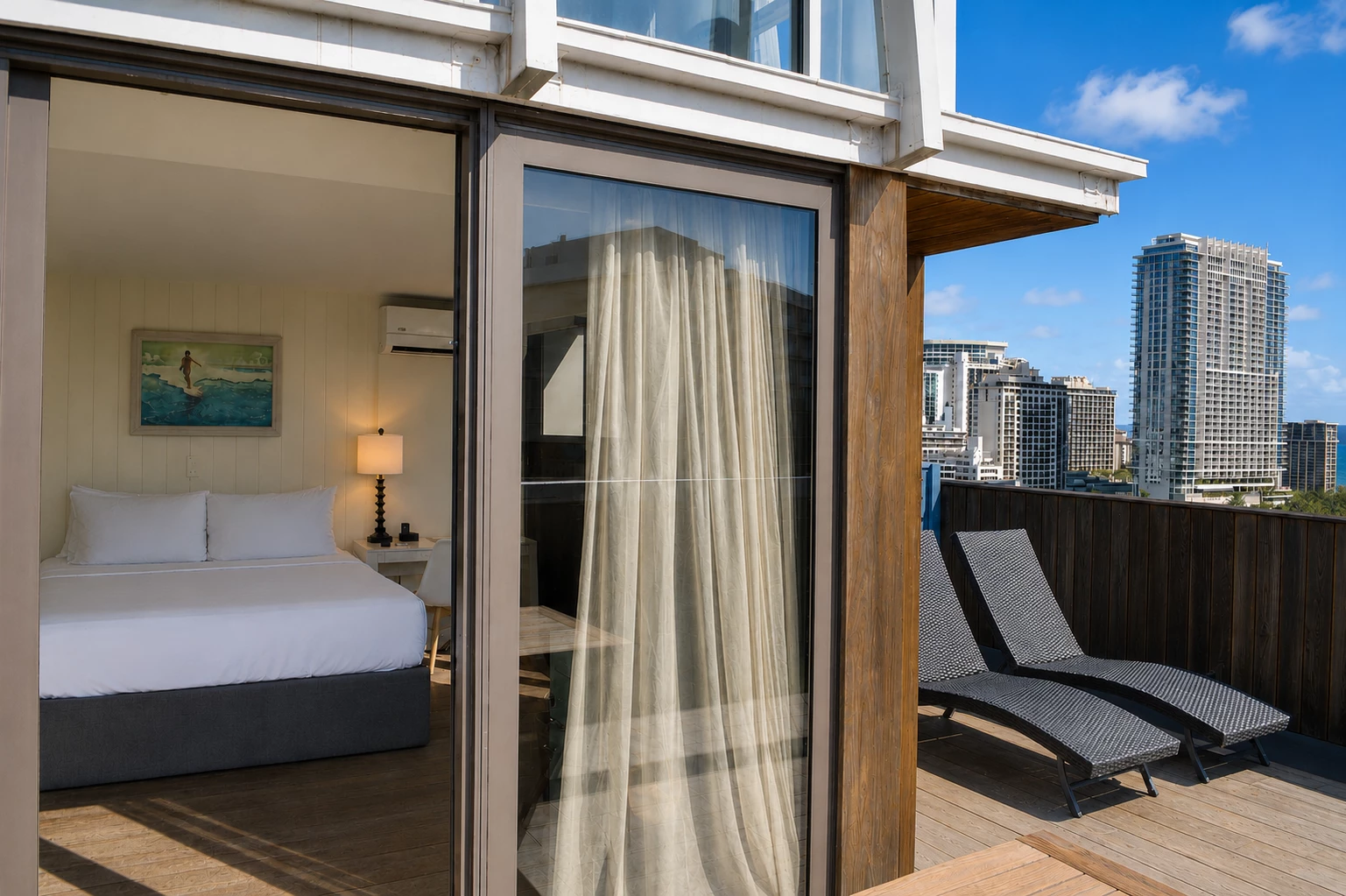 A room with a double bed, nightstand, and city view.
