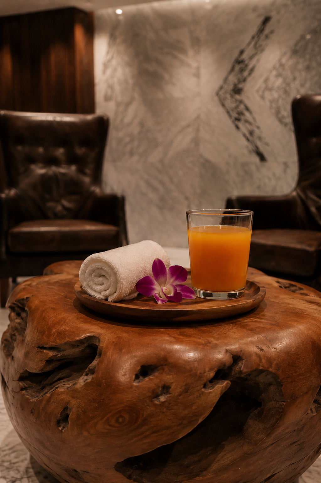 a plate of orange juice and a towel on a table