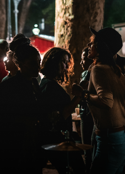 a group of women standing around a table