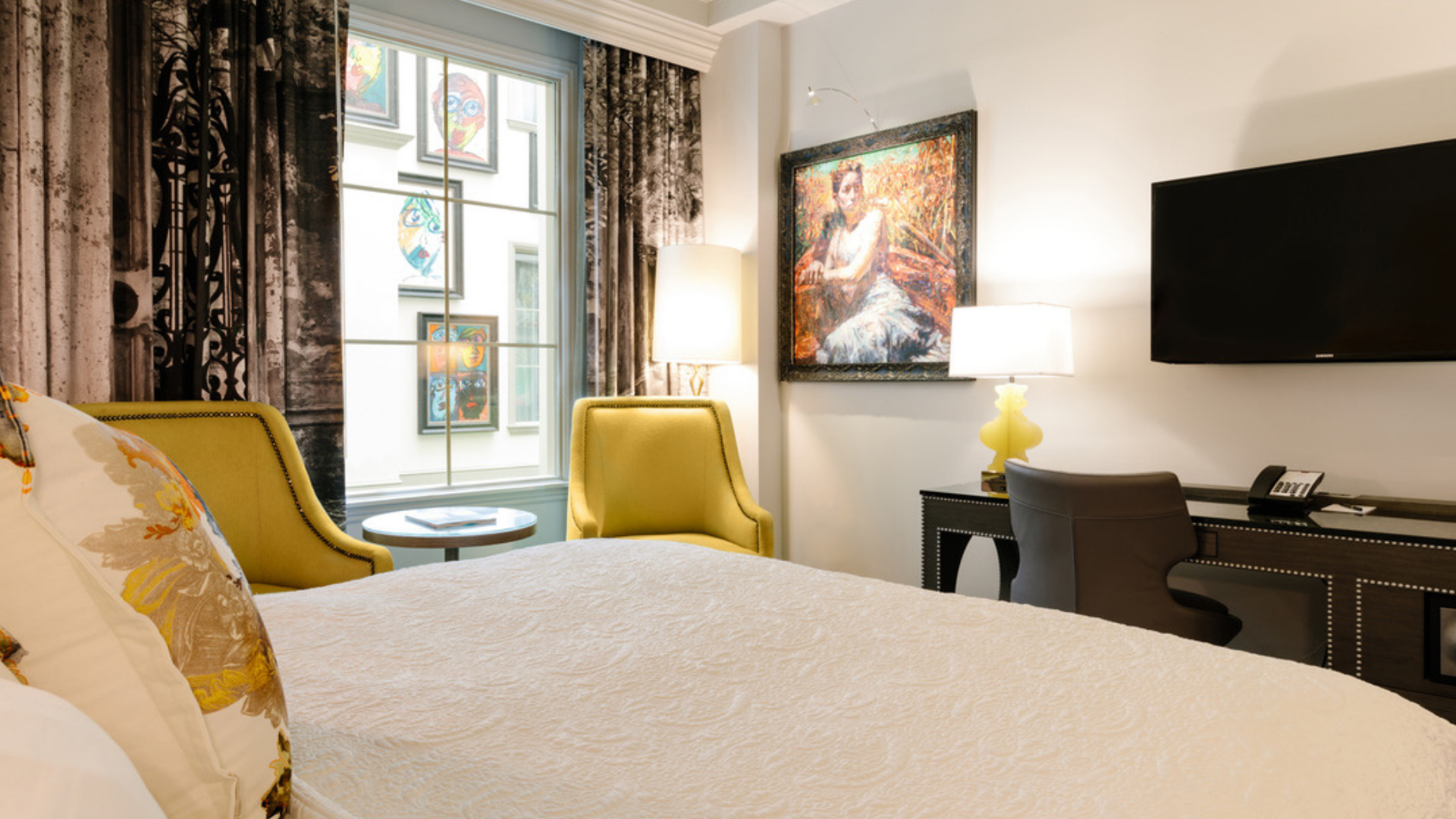 a room with a bed and two chairs