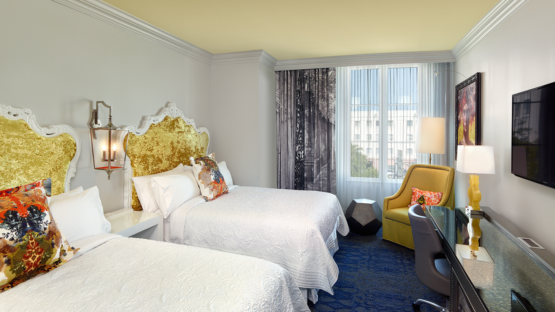a room with two beds and a desk