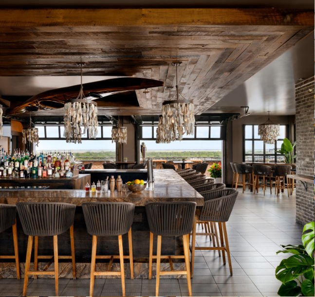 a bar with a long counter and chairs