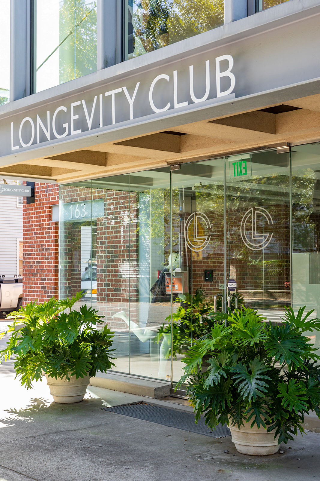 a building with glass doors and plants