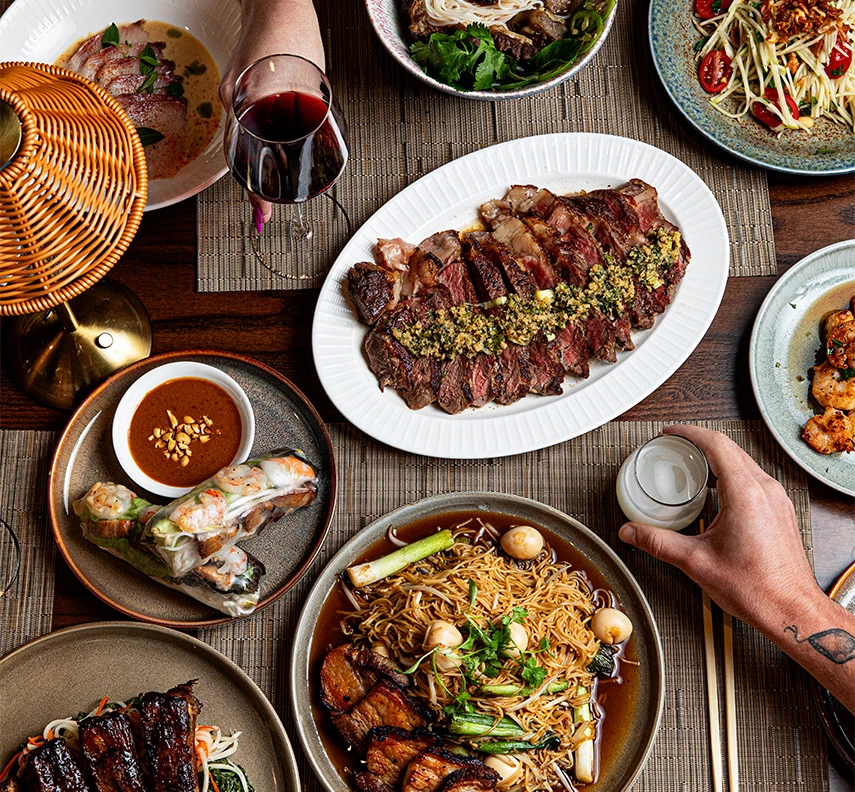 a table with plates of food and drinks
