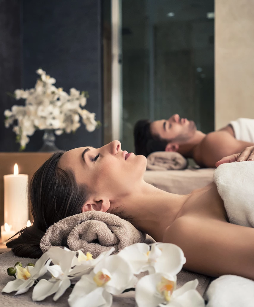 a woman lying on a bed with her eyes closed