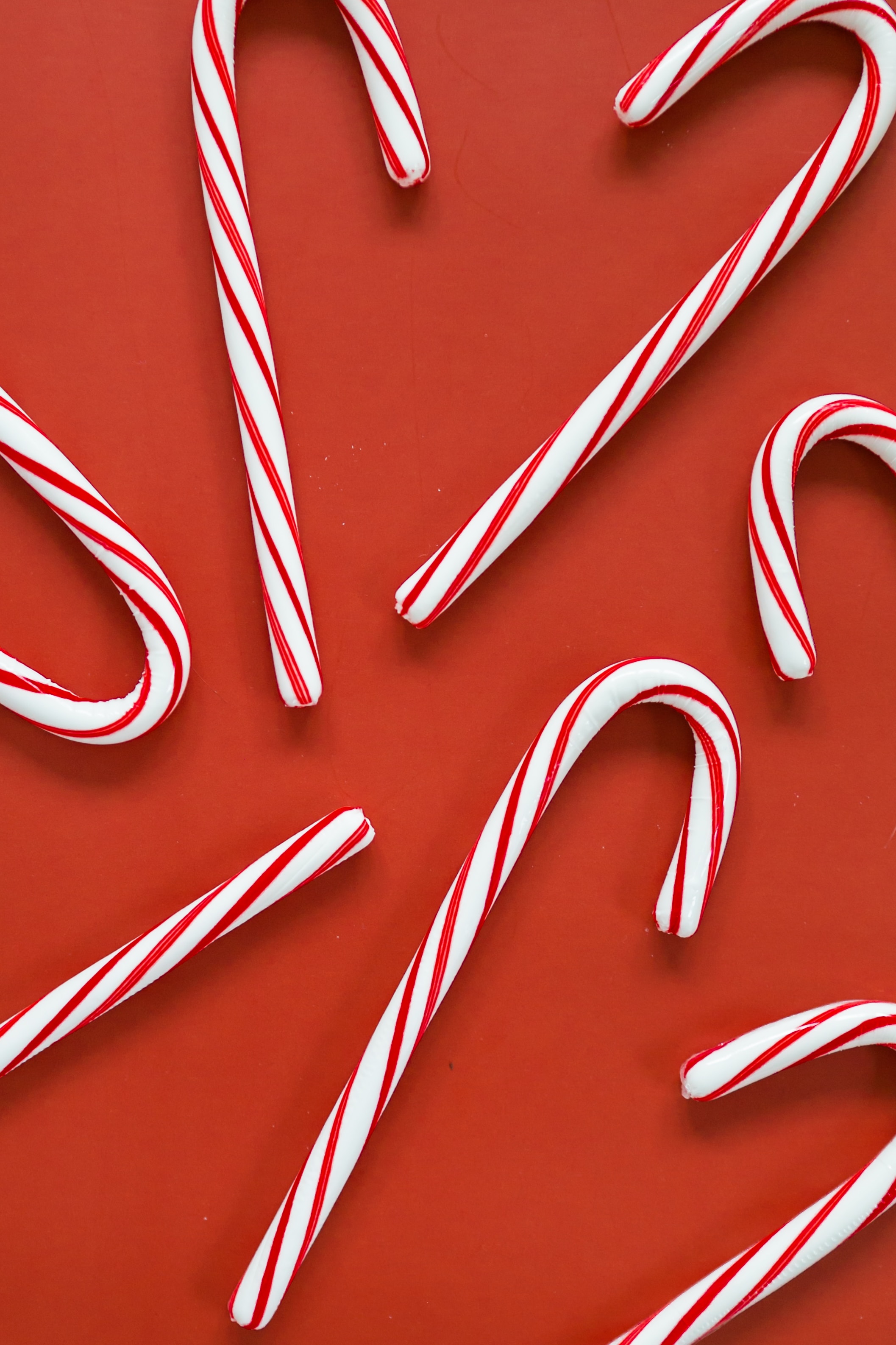 a group of candy canes on a red background