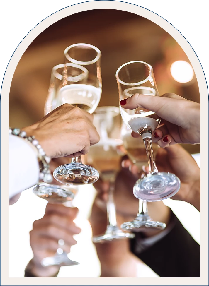 a group of people clinking wine glasses