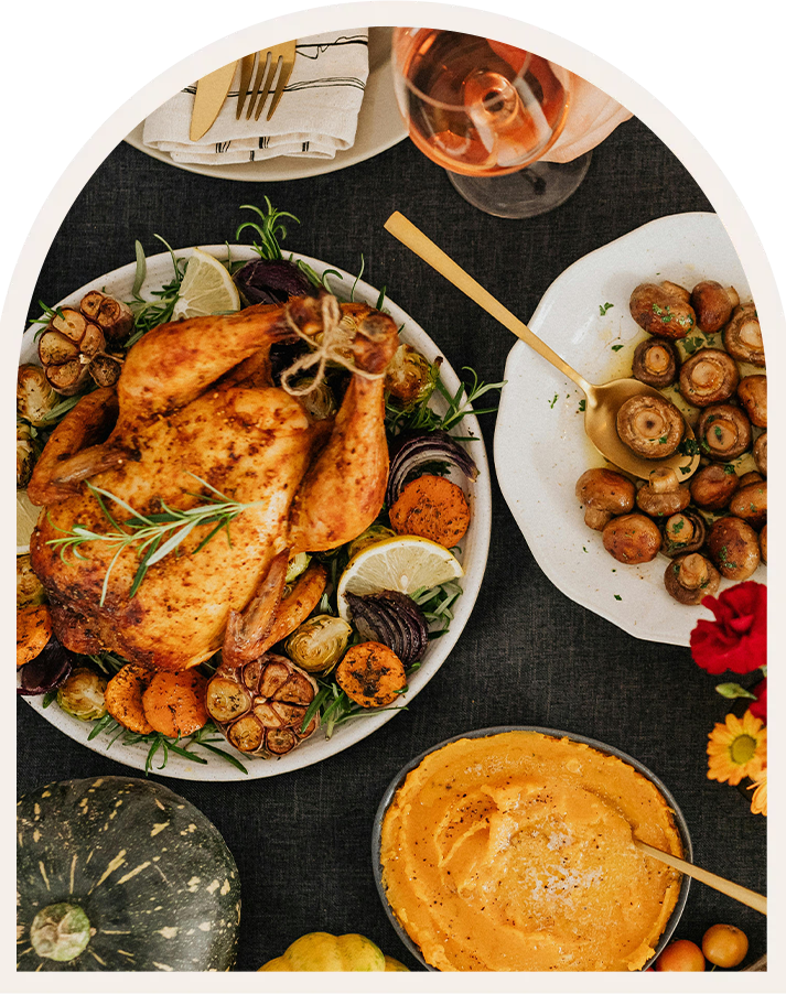 a table with plates of food and glasses of wine