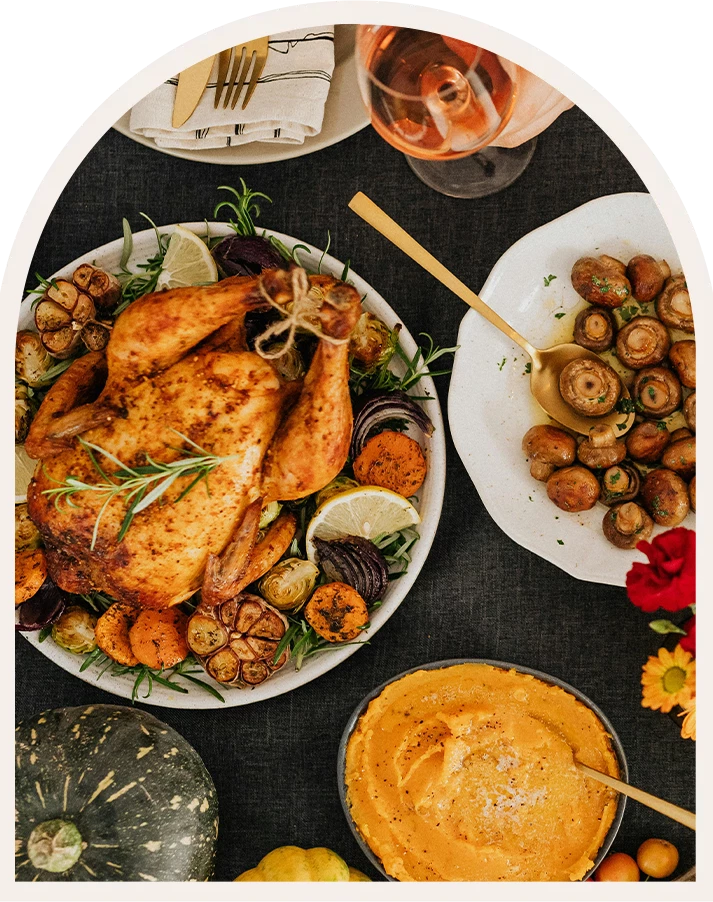 a table with plates of food and glasses of wine