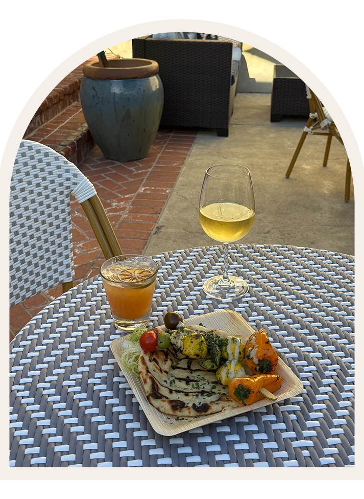 a plate of food and a glass of wine on a table