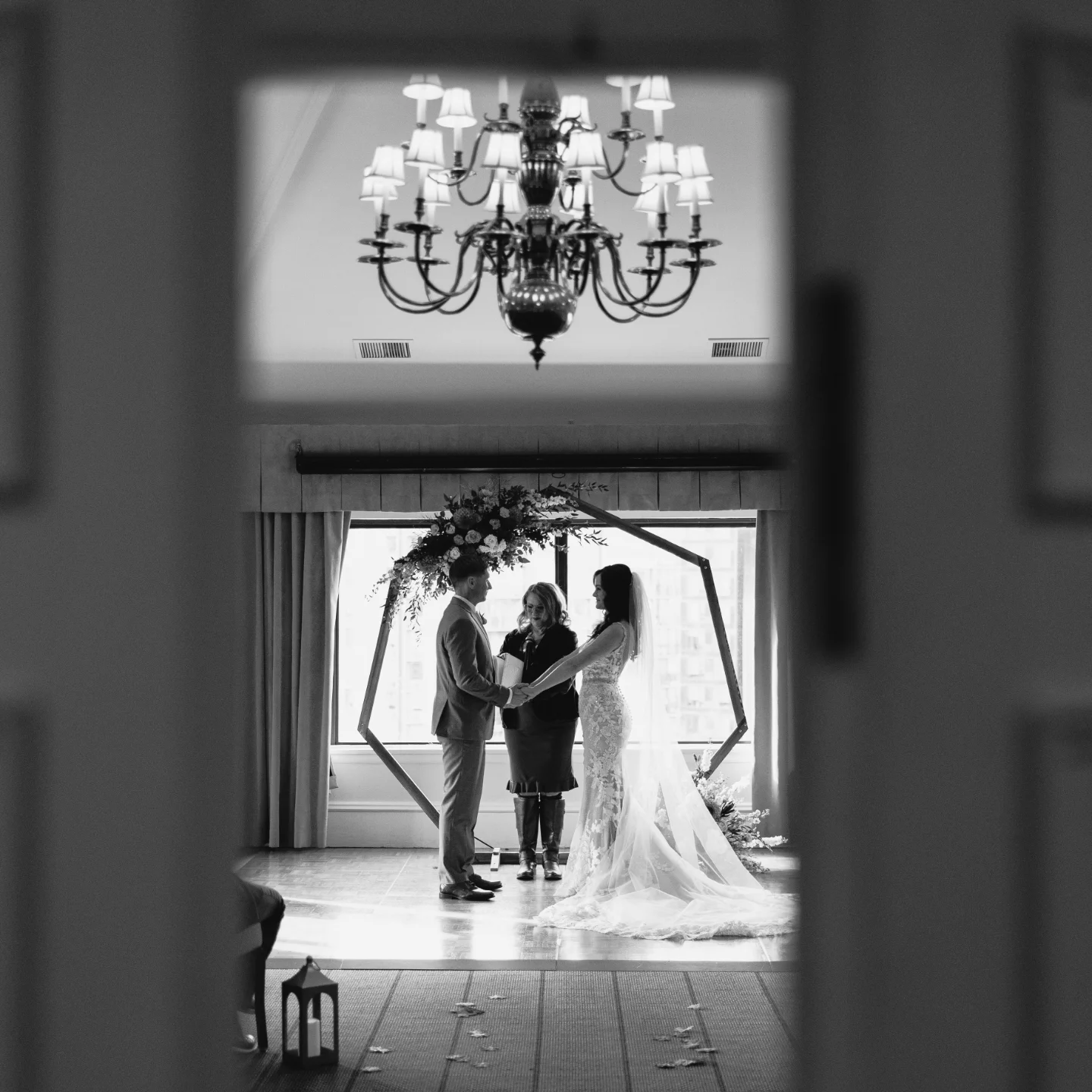 a couple standing in front of a window