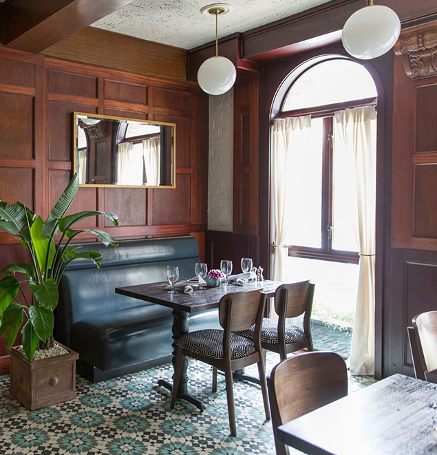 a table with chairs and a bench in a restaurant