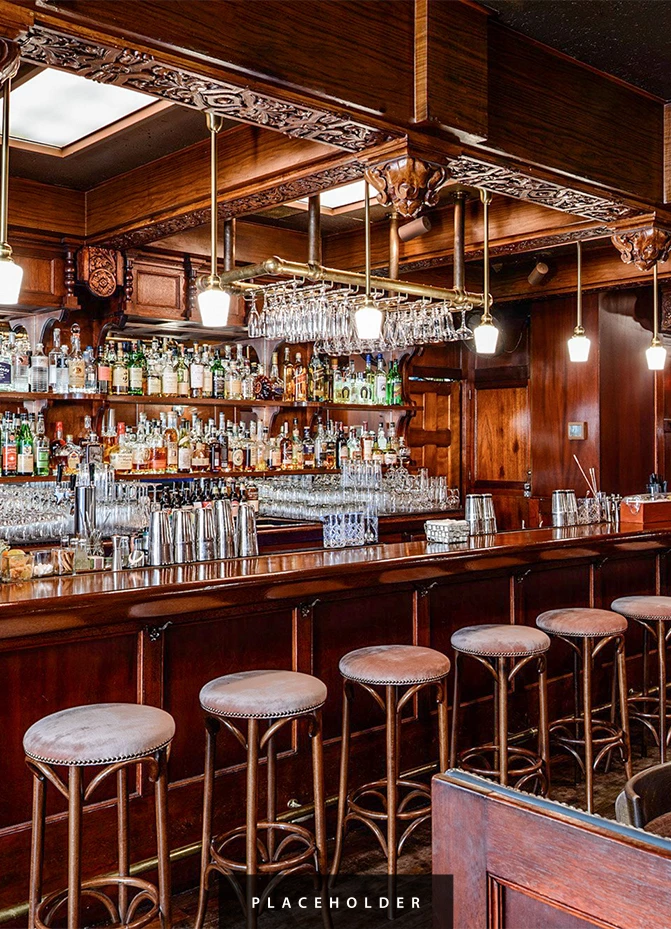 a bar with many glasses and bottles