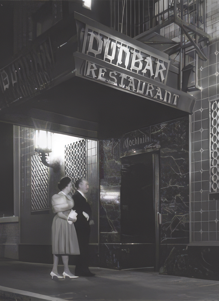 a man and woman standing outside of a restaurant