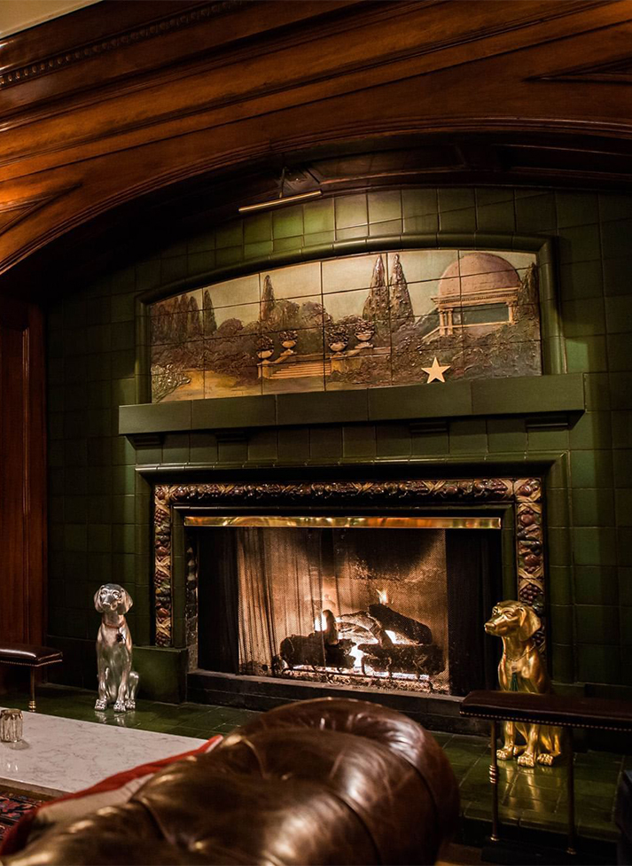 a fireplace with a dog statue in front of it